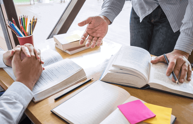 People with books and notes on a desk