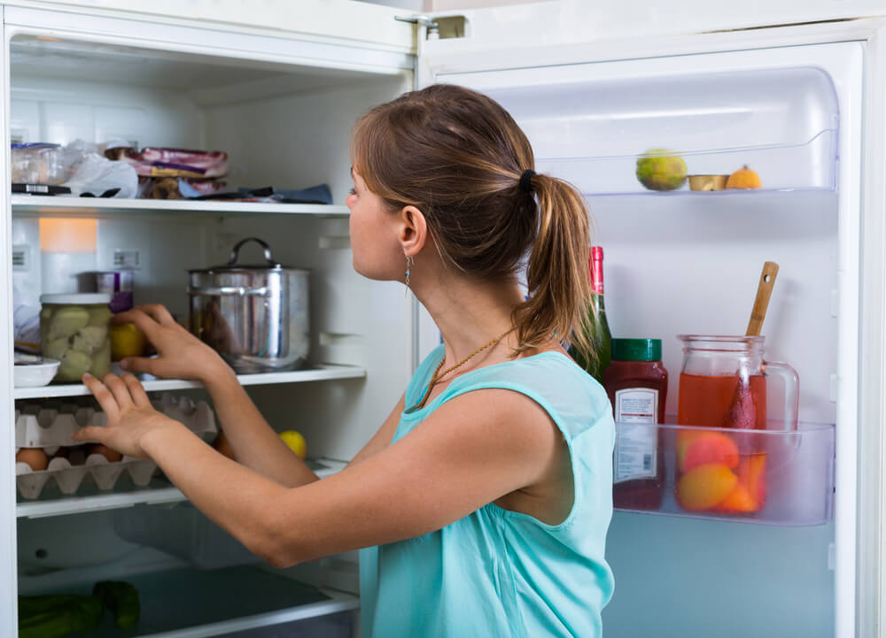 woman cleaning refrigerator
