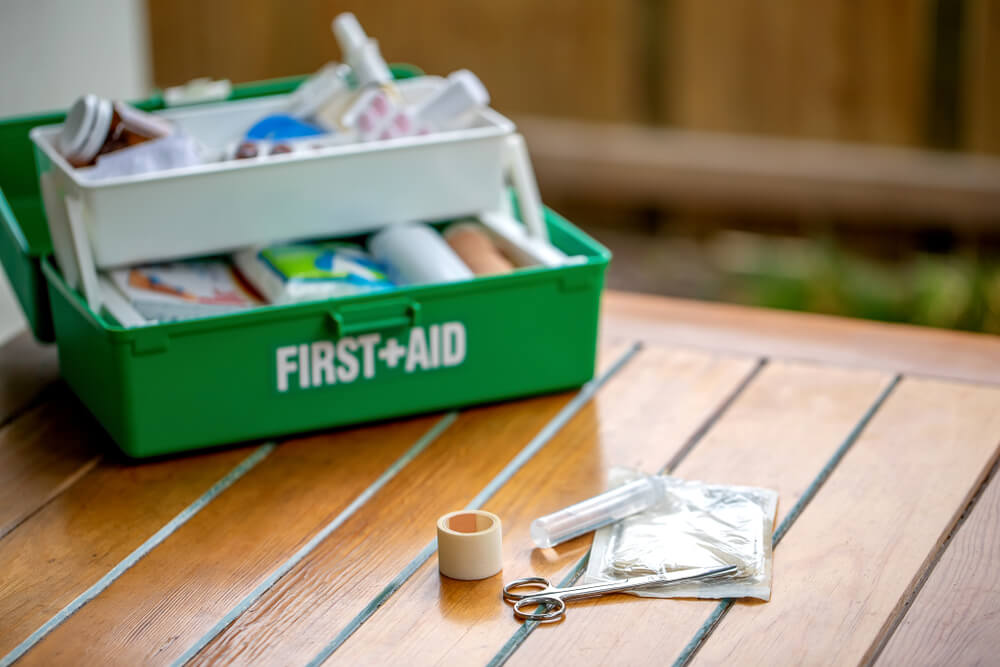 first-aid-kit-at-workplace-bandages-scissor-tweezers